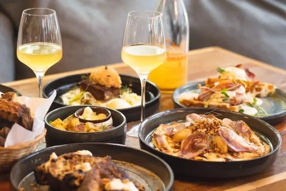 Spread of dishes and wine at Maude Épicerie in Quebec City.