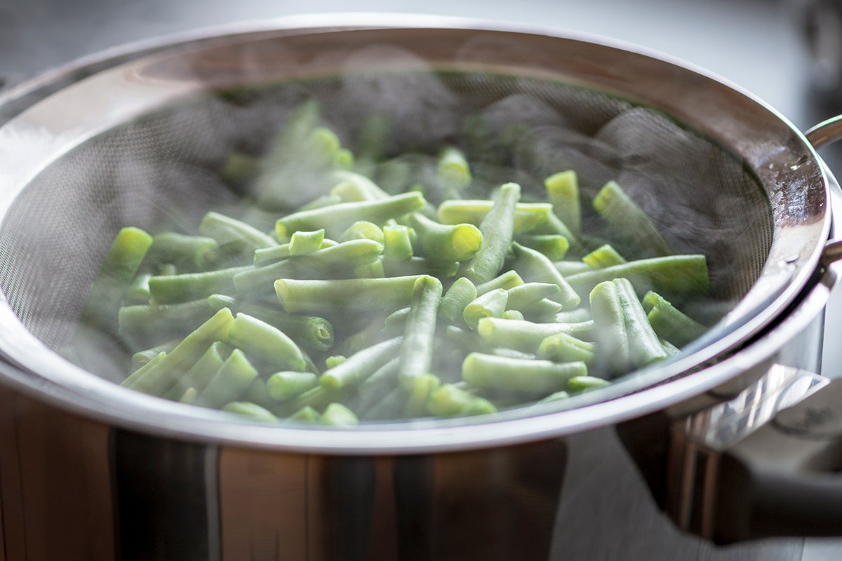 Green beans or green beans being boiled/sauteed.