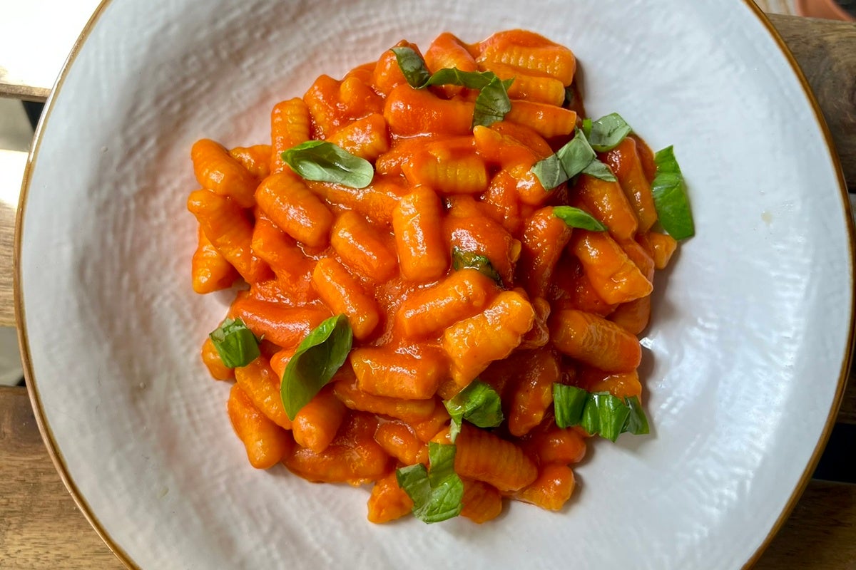 Cooked cavatelli in a red sauce with herbs.