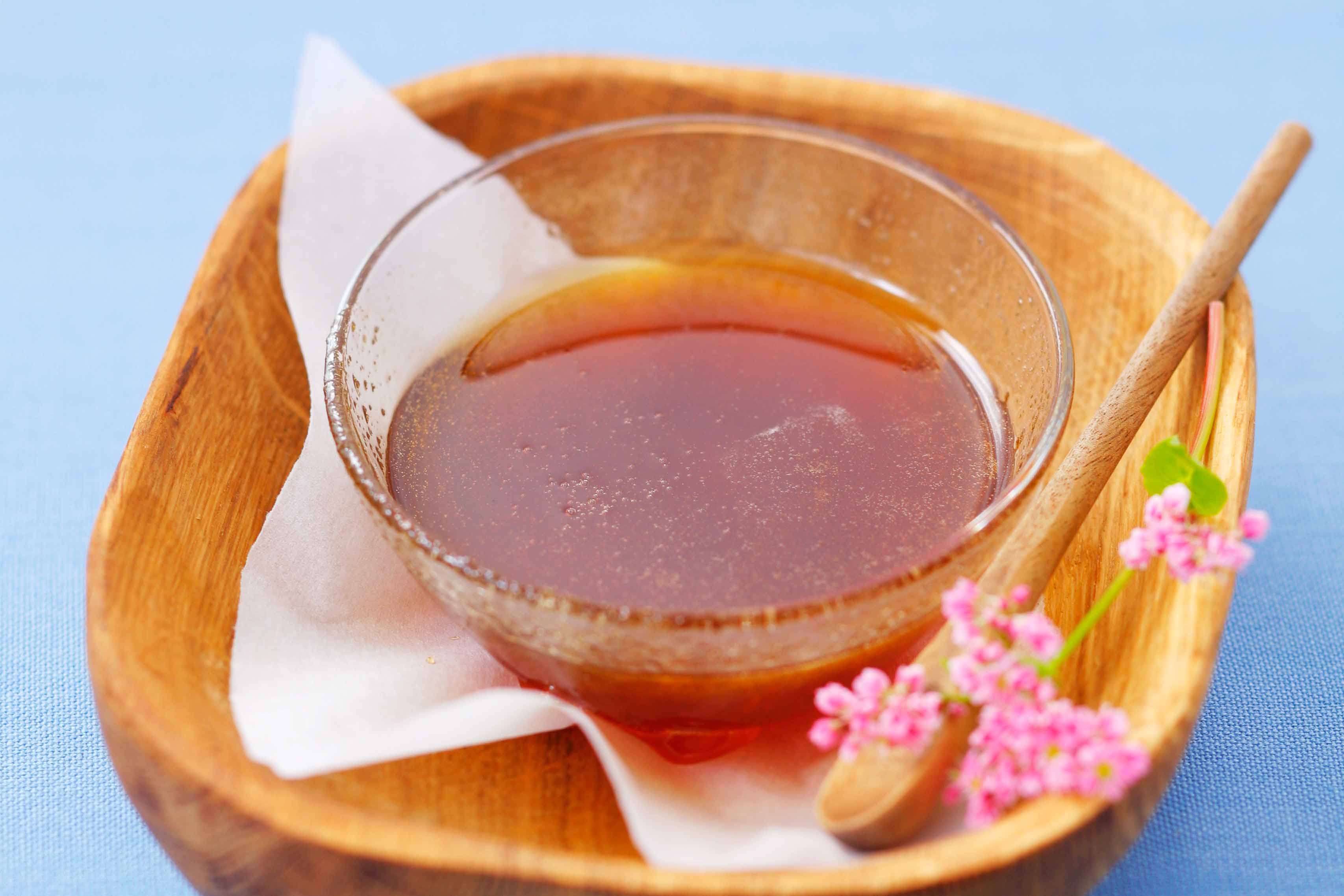 a glass bowl of buckwheat honey