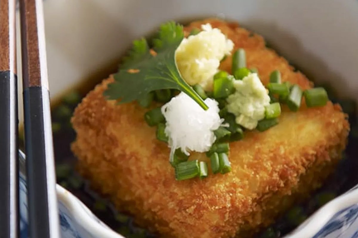 Deep-fried tofu with wasabi, daikon, and herbs.