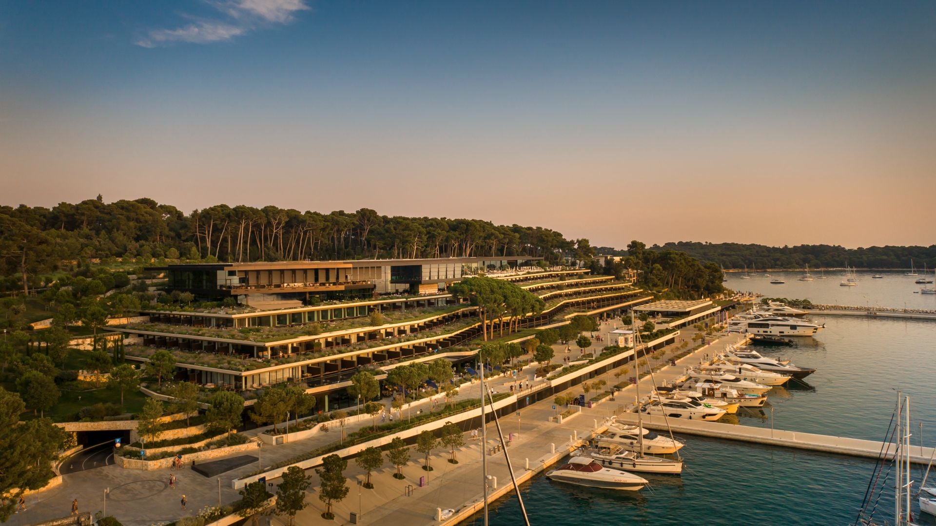 a modern design hotel fronted by a harbour