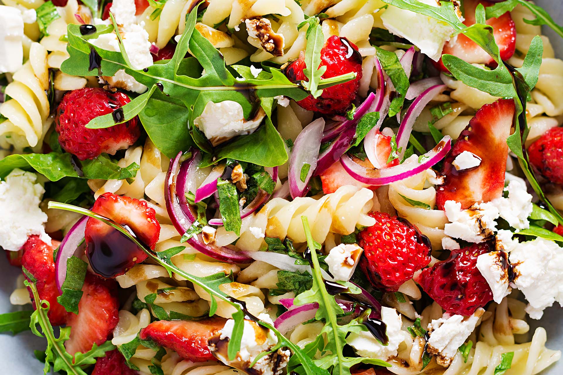Pasta and strawberry salad with feta cheese.