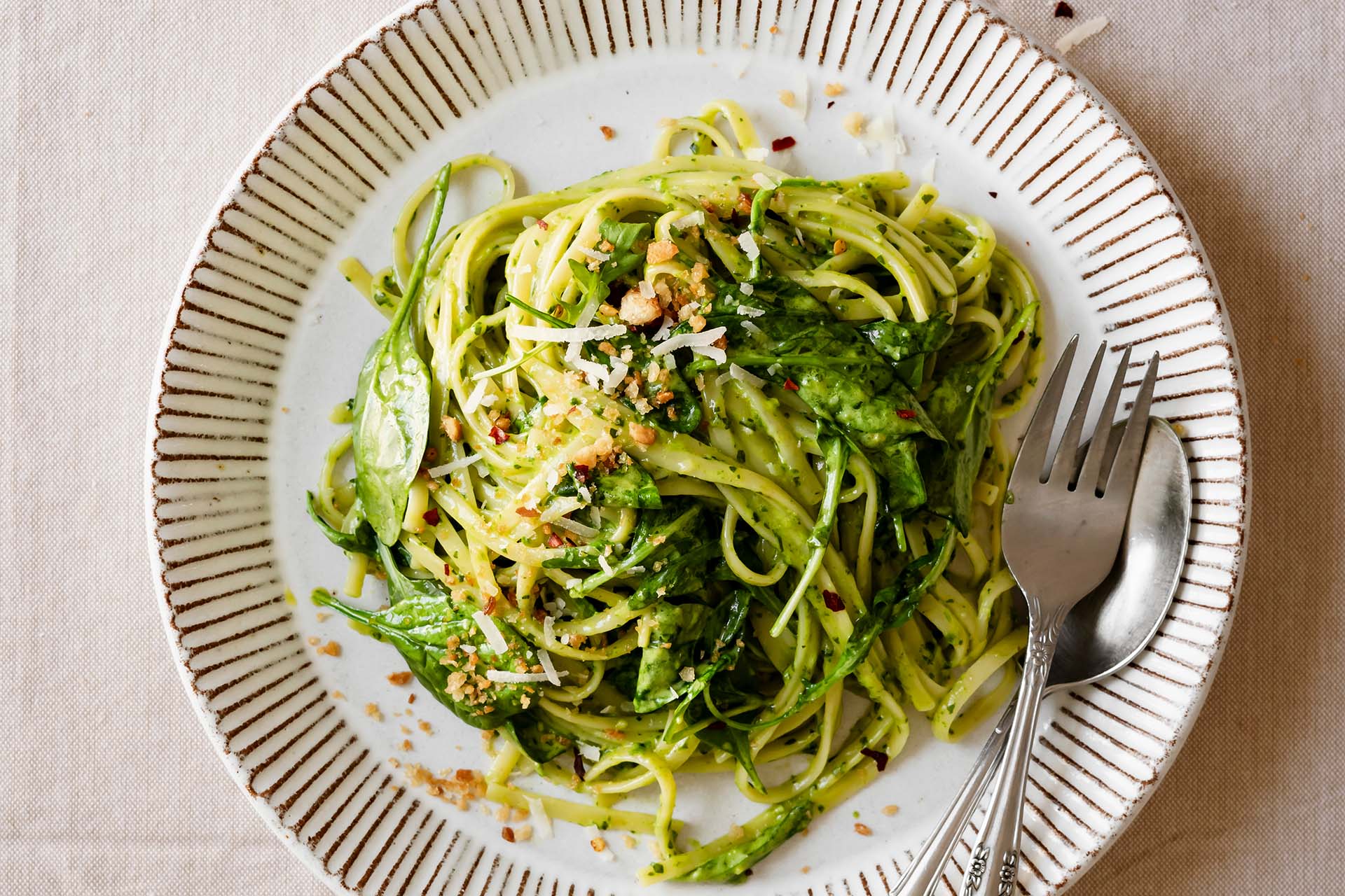 Creamy pesto pasta with crushed red pepper and Parmesan cheese
