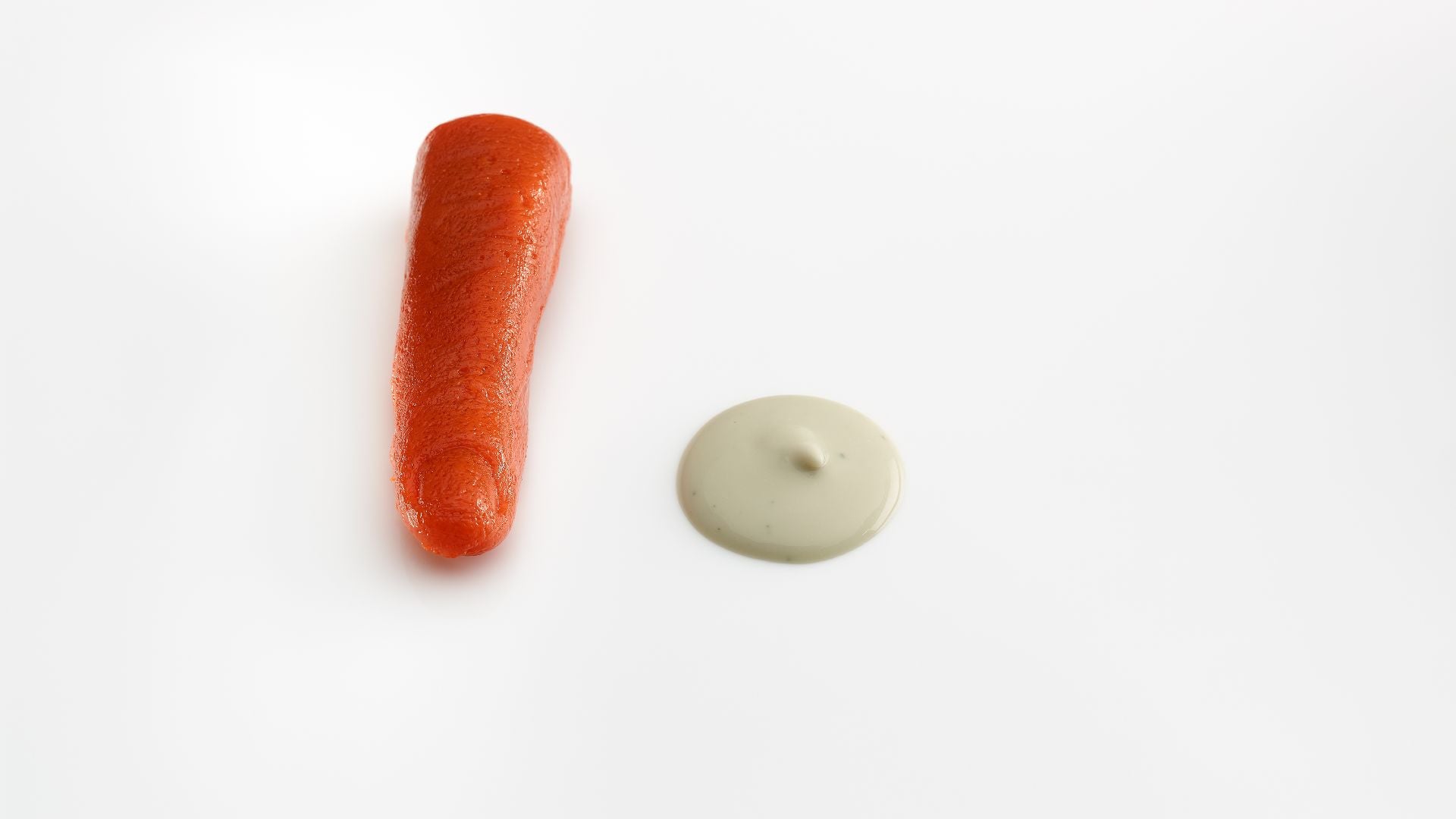 an orange finger next to white sauce