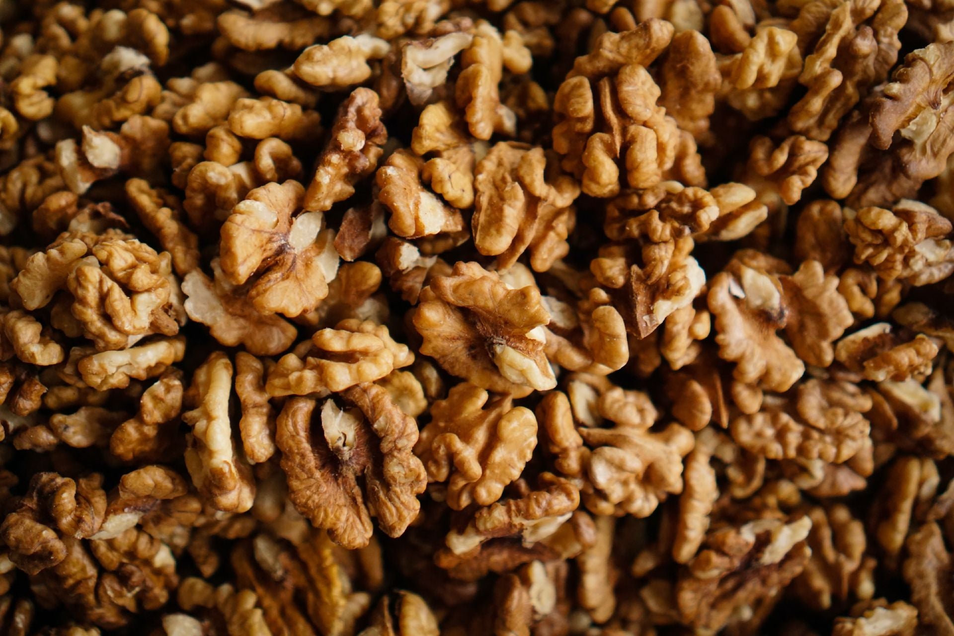 An overhead of a heap of shelled walnuts