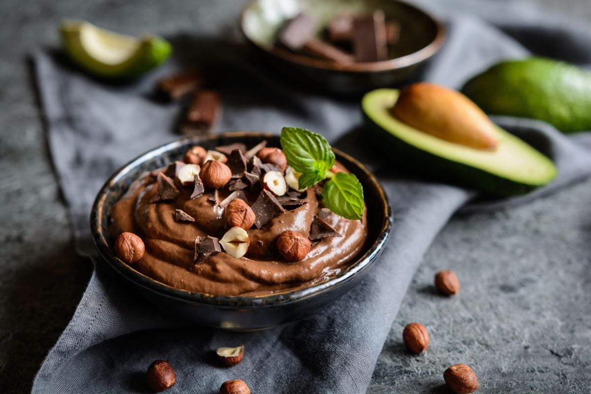 Cup of avocado chocolate mousse with nuts