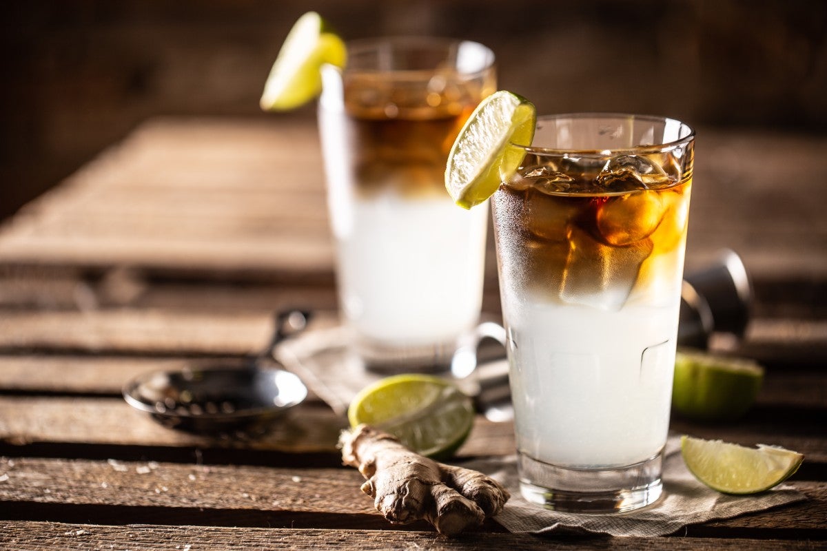 Two glasses of Dark 'n' Stormy cocktail combining dark rum with ginger beer