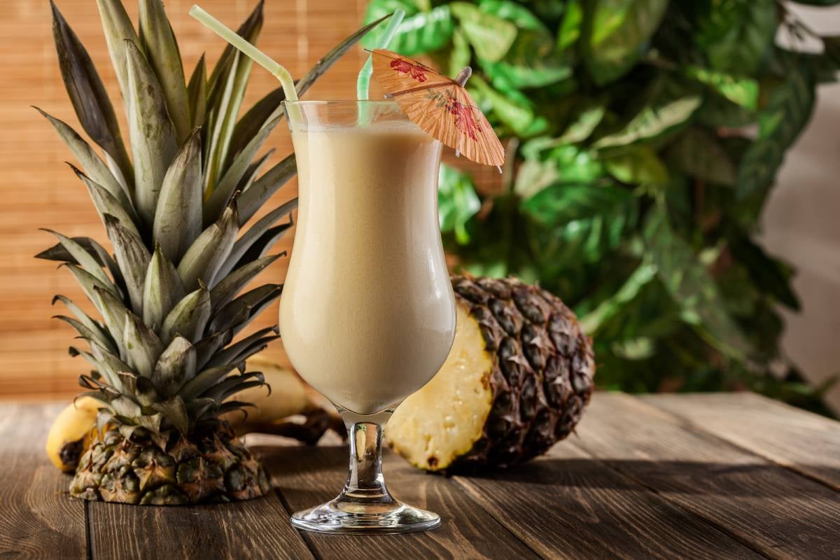 A glass of Piña colada cocktail made with rum and pineapple juice