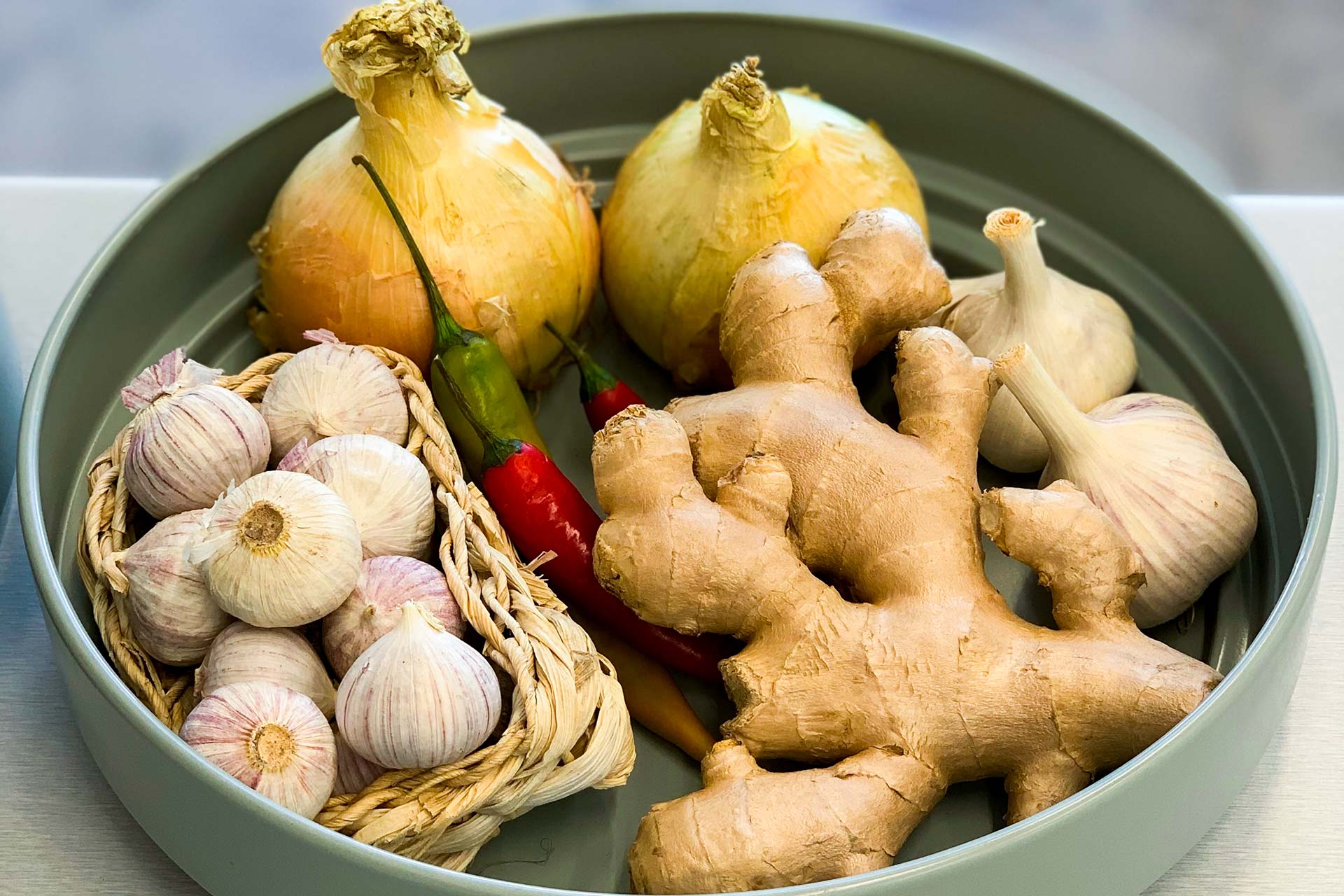 Onion, garlic, ginger and chilli in a bowl.