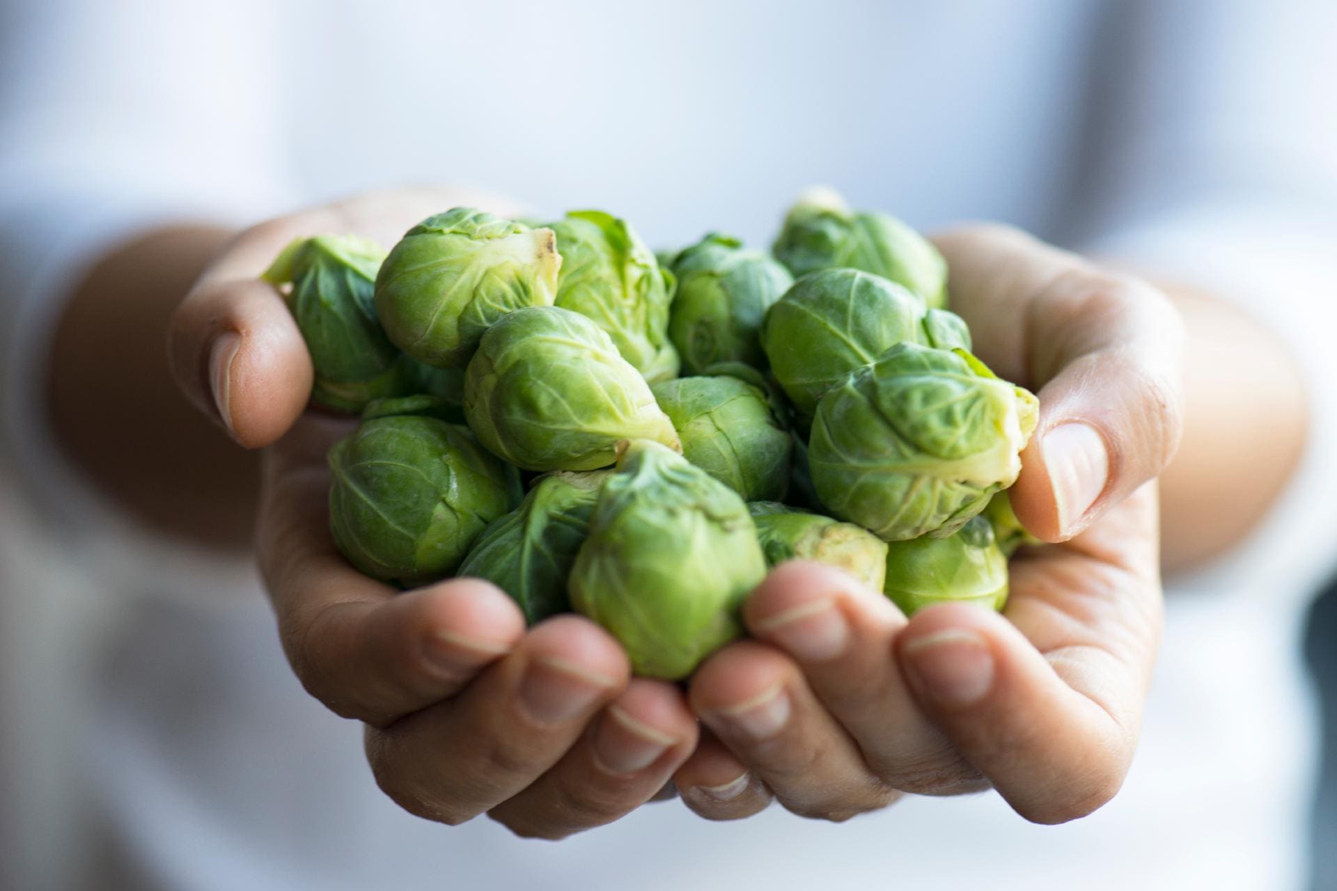 hands holding brussels sprouts ©iStock