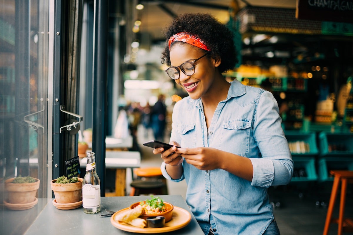 Girl taking meal picture and scrolling mindlessly phone