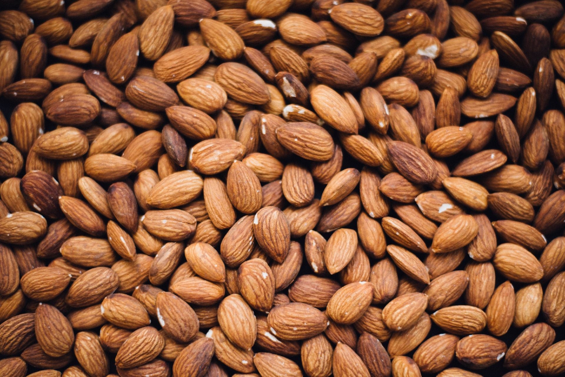an overhead photo of heaps of shelled almonds