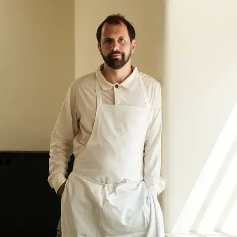 Chef Merlin Labron-Johnson standing next to a window.