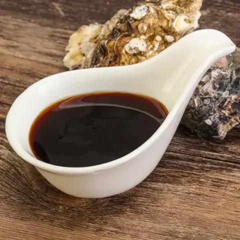 Oyster sauce and two oyster shells.