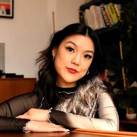 Journalist Angela Hui in a homely room.