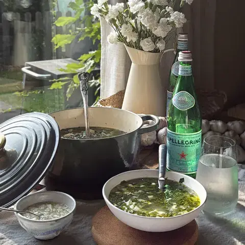 Chicken and Swiss chard soup and a bottle of S.Pellegrino.