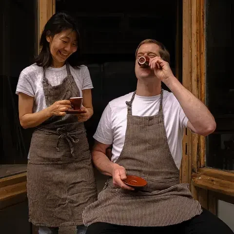 Kyu Jeon and Duncan Robertson drinking coffee.