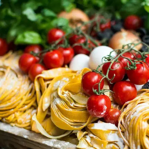 Raw fresh pasta and cherry tomatoes.