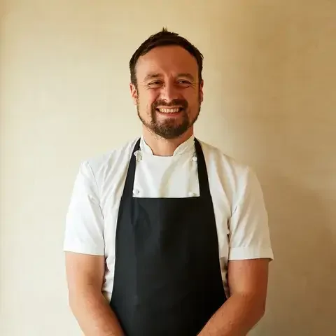 Chef Sam Carter smiling in an apron