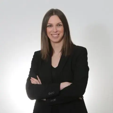 Journalist Federica Artina in a black suit.