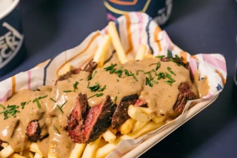 Steak and chips covered in sauce at Beef on the Block.