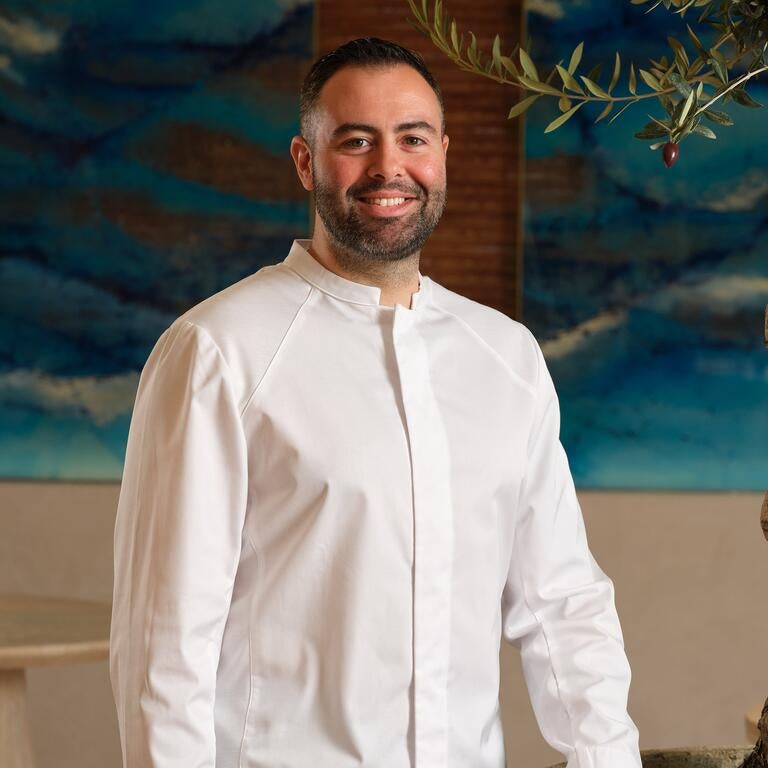 Chef Asimakis Chaniotis, smiling.
