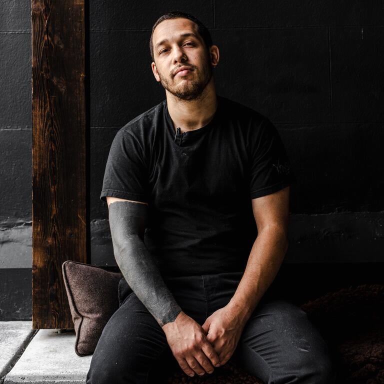 Chef Corrin Harrisson in a black t-shirt and jeans.