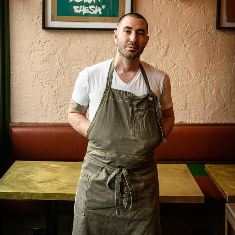 Chef Jake Finn in an apron at Cinder.