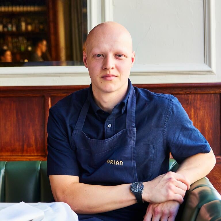 Chef Max Coen seated at Dorian.