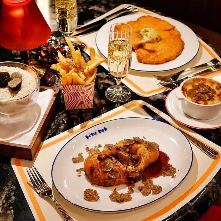 Rotisserie chicken and dishes at Bébé Bob in London.