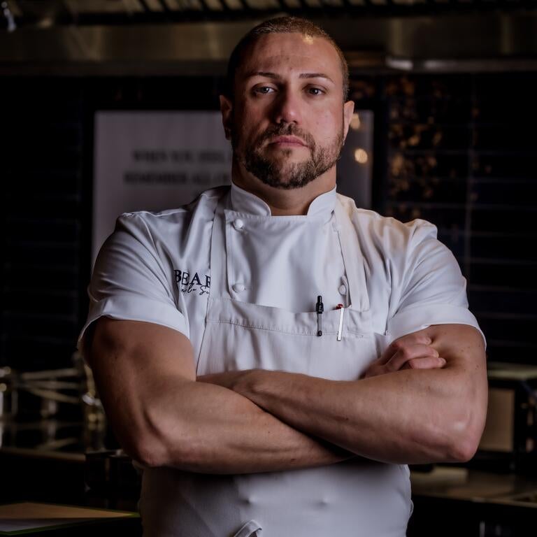 Chef Carlo Scotto with his arms folded.