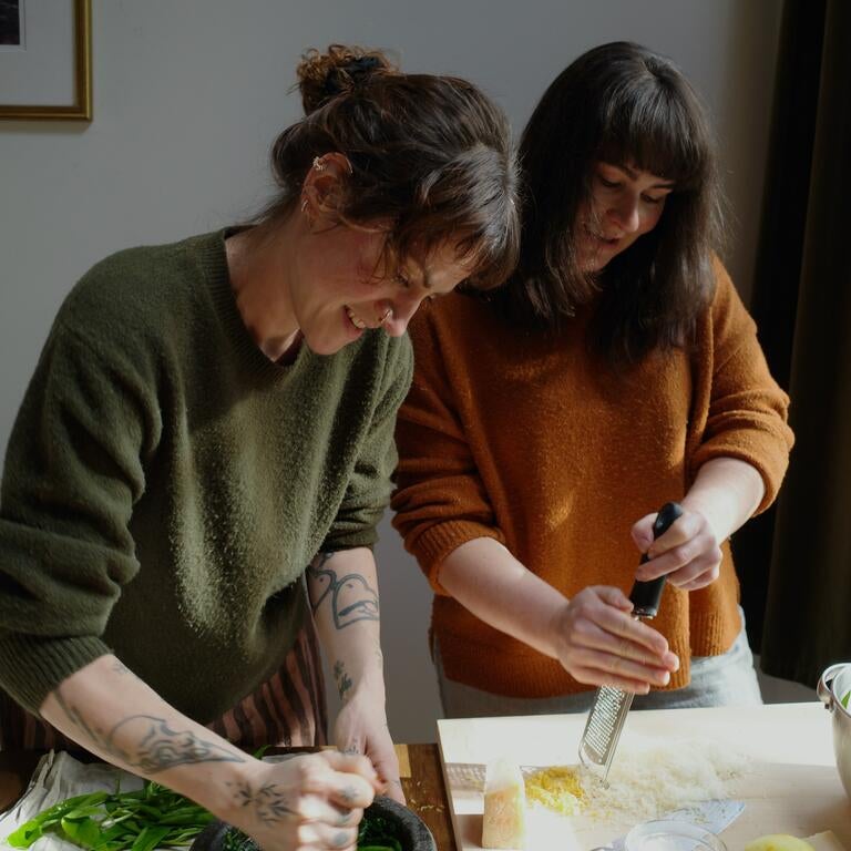 Emily Cuddeford and Rachel Morgan preparing a dish.