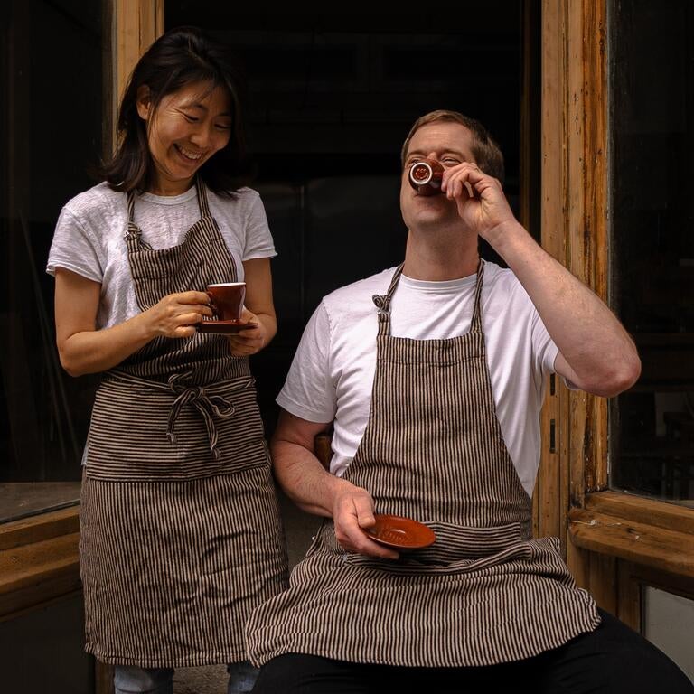 Chefs Kyu Jeon and Duncan Robertson drinking coffee outside Dongnae.