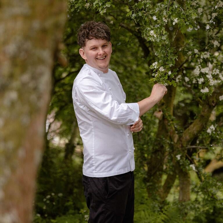Chef Calum Montgomery in a garden.