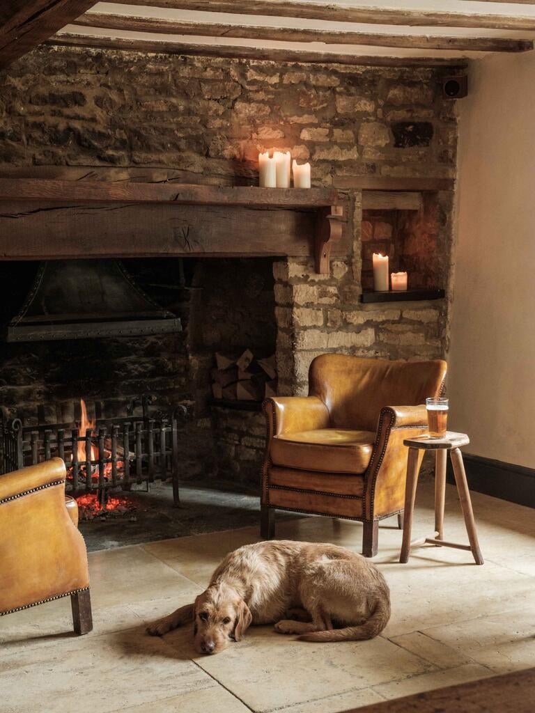 Cosy scene at The Bull, Charlbury, with a dog and fire.