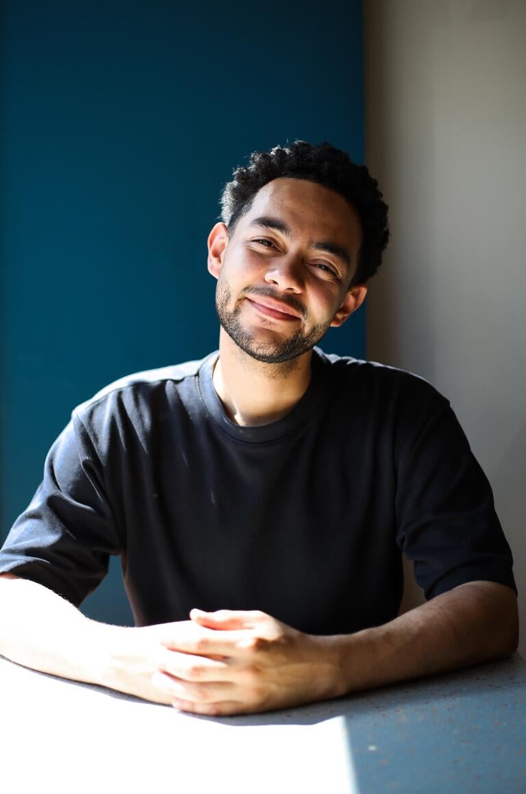 Chef Aidan Richardson, seated and bathed in light.