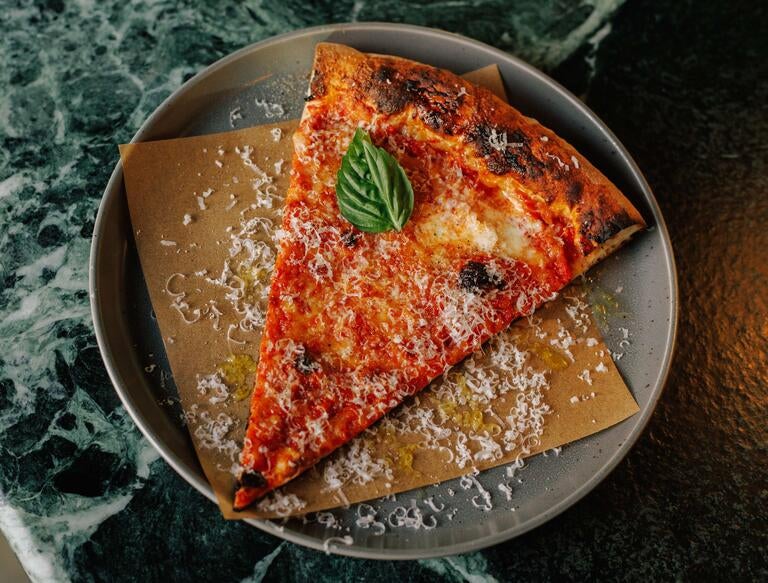 Slice of tomato pizza at Miami Slice.