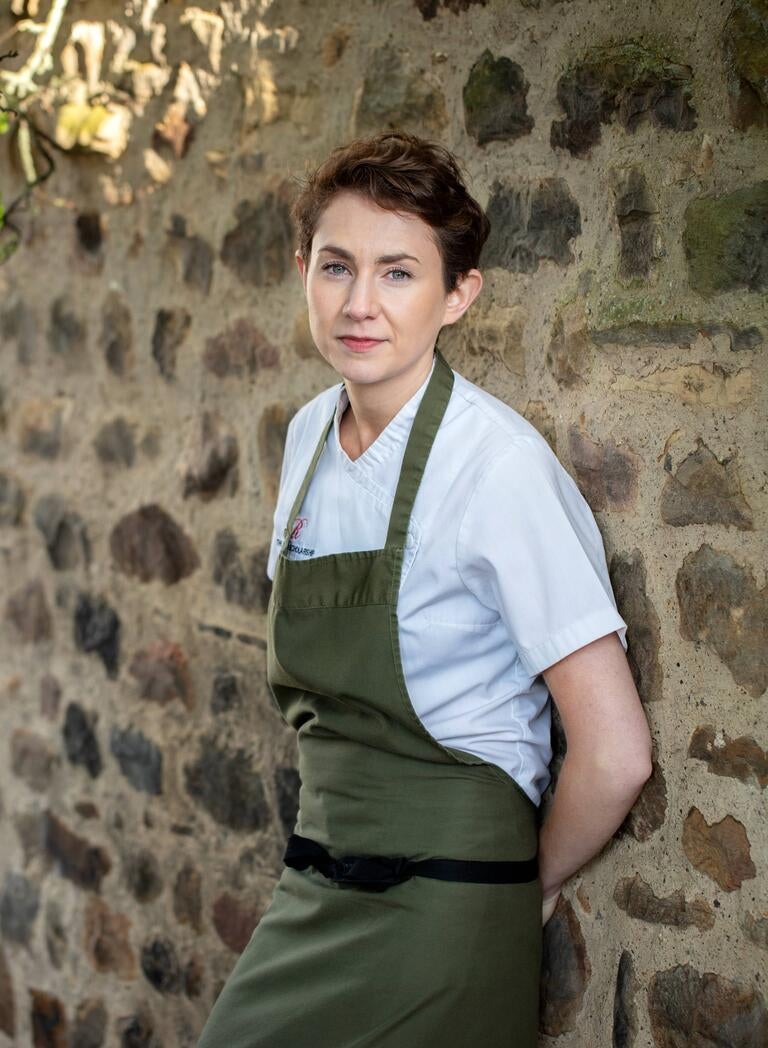 Chef Ruth Hansom leaning against a wall.