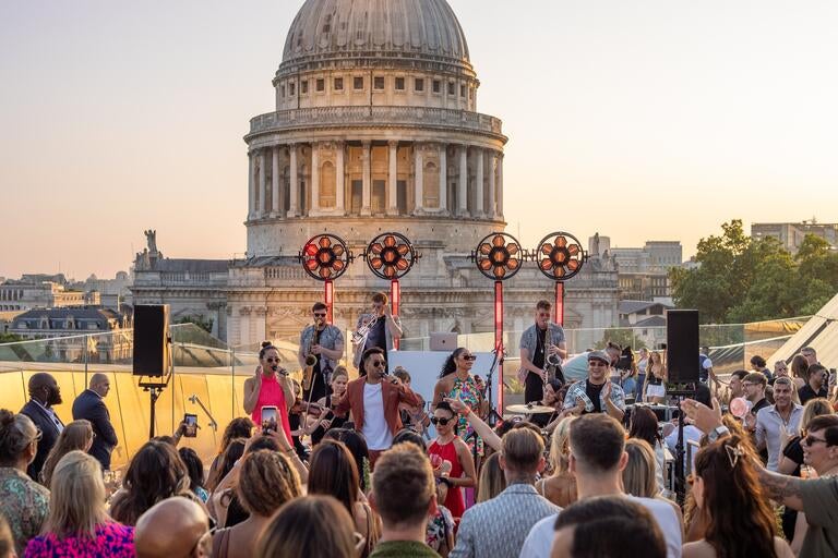 Live music performers at Madison, with St Paul's Cathedral in the background.