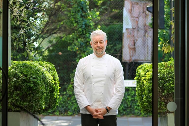 Adam Byatt outdoors in a chef's jacket.
