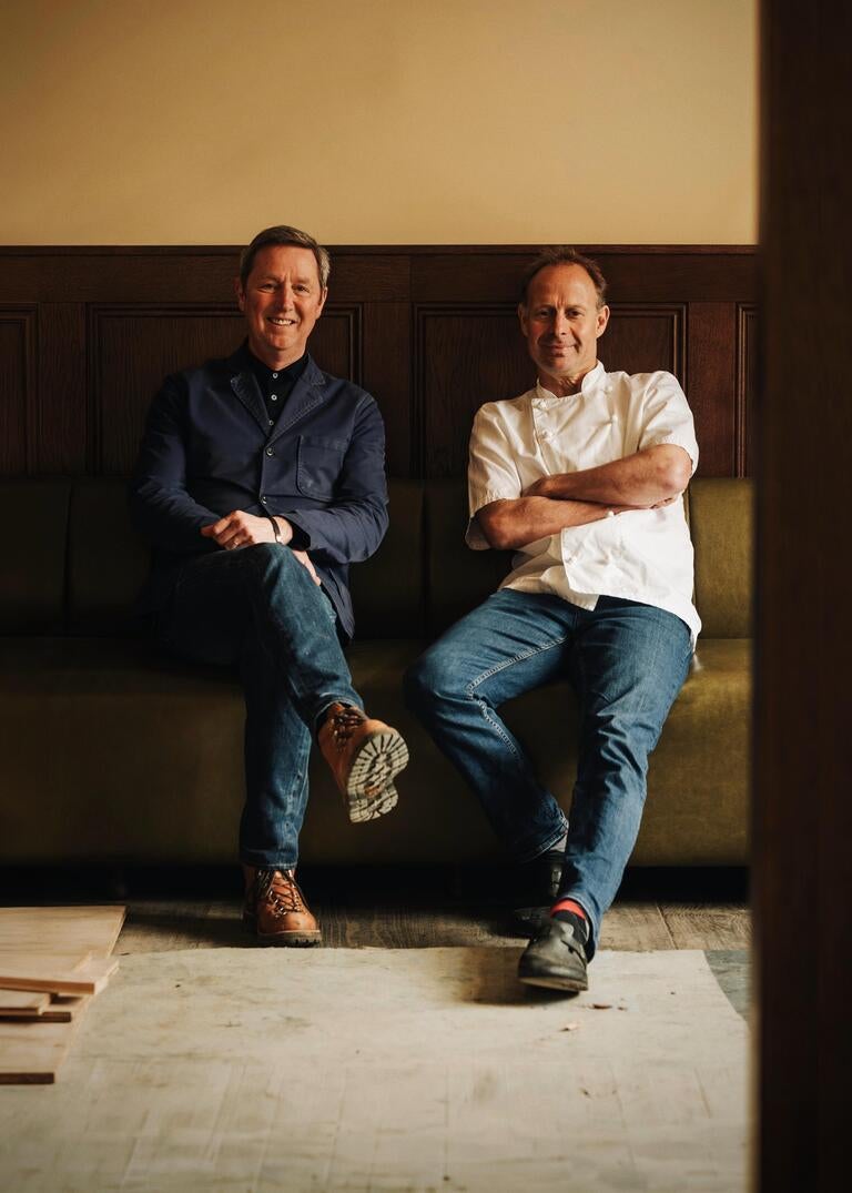 Nigel Sutcliffe and Dom Chapman, seated and smiling.
