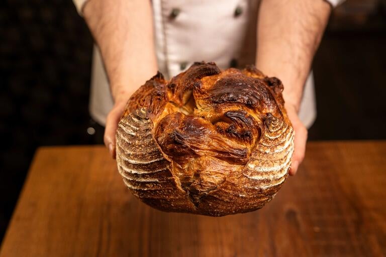 A person holding a loaf of bread at Cerere.