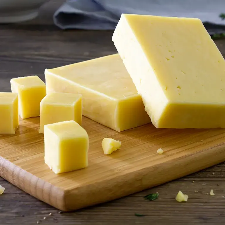 Cheddar cheese on a board.