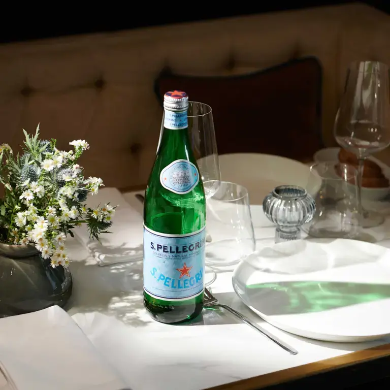 A bottle of S.Pellegrino on a table