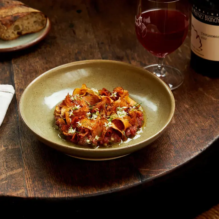 A table set with food and wine at Goodbye Horses.