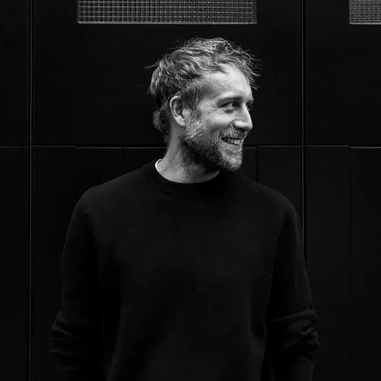 Chef Rob Roy Cameron looking sideways in a dark sweatshirt.