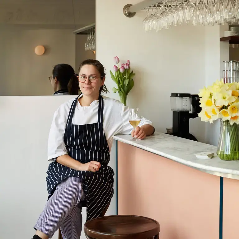 Chef Anna Tobias seated at the bar of Cafe Deco.