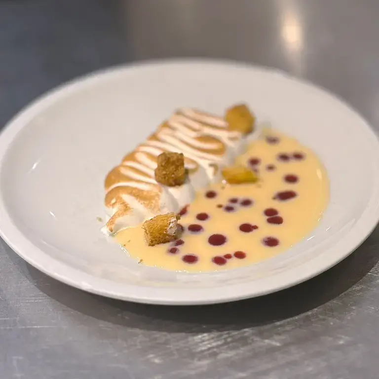 Meringue, pandoro and red berry coulis.
