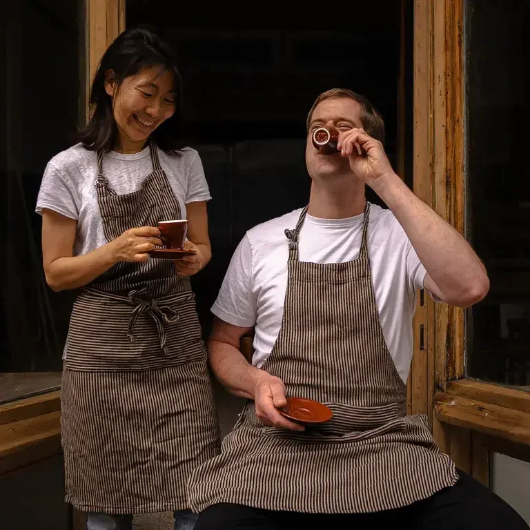 Kyu Jeon and Duncan Robertson drinking coffee.